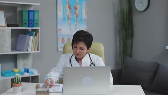 Female Doctor Making Online Video Call Consulting Patient