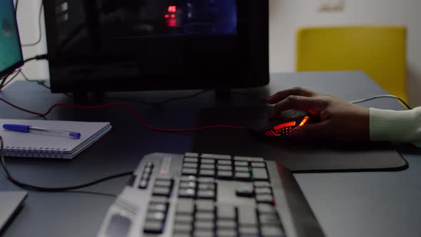 Close Up of Streamer Holding RGB Mouse Playing Space Shooter Videogame alt