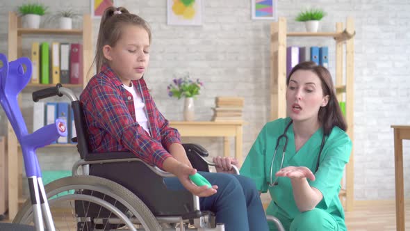 Teenage Girl Is Undergoing Rehabilitated By a Doctor After a Hand Injury with the Help of a Wrist alt