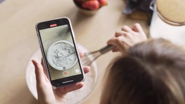 Skilled Culinary Blogger Holds Smartphone and Makes Video
