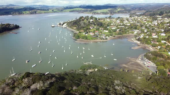 Rising aerial drone of the quaint Mangōnui town, harbour and boats in Northland, New Zealand, Aotear alt