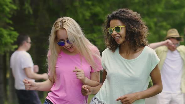 Two Multiracial Friends Dancing at Pool Party and Smiling, Enjoying Holidays alt