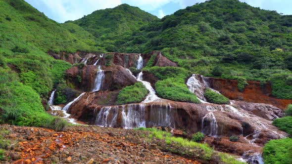 Golden waterfall. Nature landscape of Jinguashi in Ruifang area, Taipei, Taiwan. alt