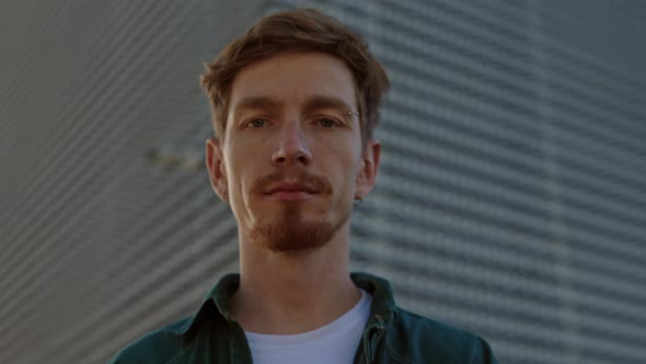 Caucasian Redhead Man Looking at Camera with Calm Face alt