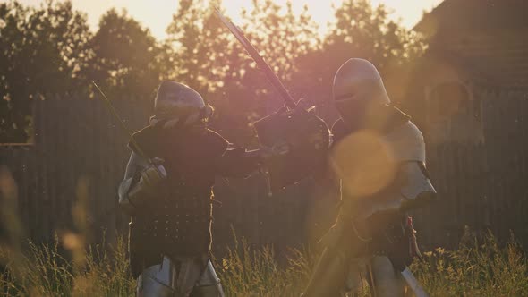 Battle of Two Knights in Armor at Sunset alt