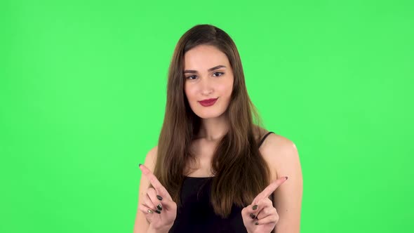 Cute Girl Smiles and Showing Heart with Fingers Then Blowing Kiss. Green Screen alt