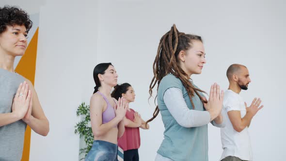 Slow Motion of Yoga Students Spiritual Young People Doing Balance Exercises in Studio alt