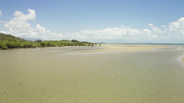 Low Tide And Huge Sand Ocean Bed Mangroves Growing And A White Egret Hunting