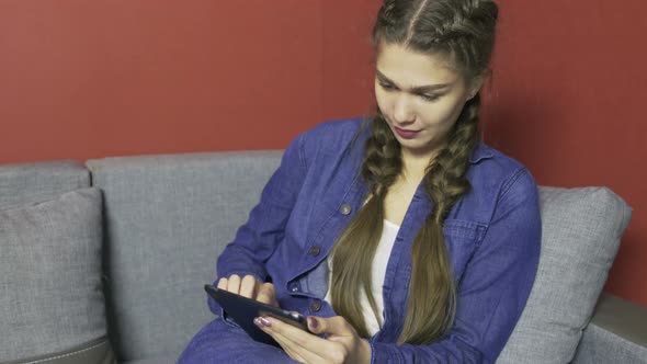 Girl Using Tablet at Home