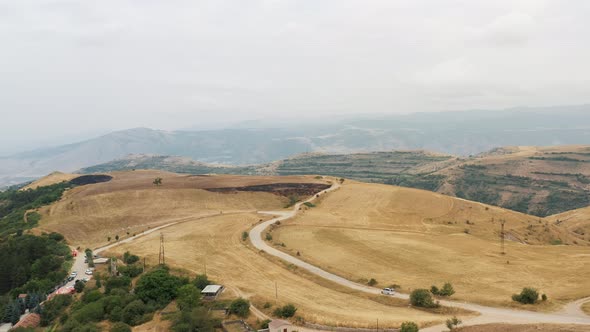 Aerial Drone Zoom in of Hills, Road and Mountains in Armenia