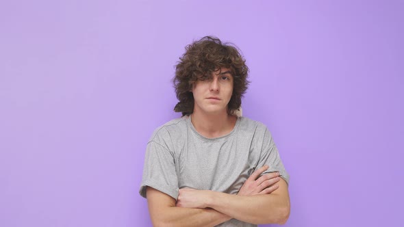 A Young Guy with Curly Hair Smiles at the Camera on an Isolated Background a Pet Rat is Sitting on alt