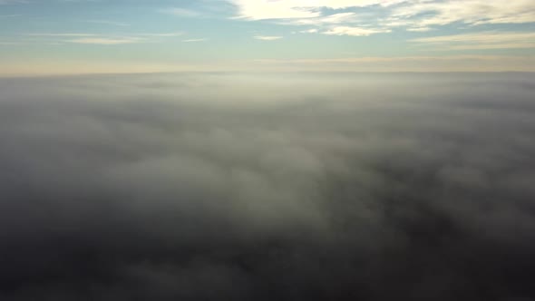 Aerial Drone View Flight Over Above Fog Mist and Roofs of Buildings in City alt