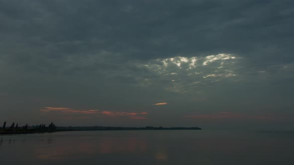 Rising Sun Behind The Clouds, Calm River, Cloudy Weather, Time Lapse