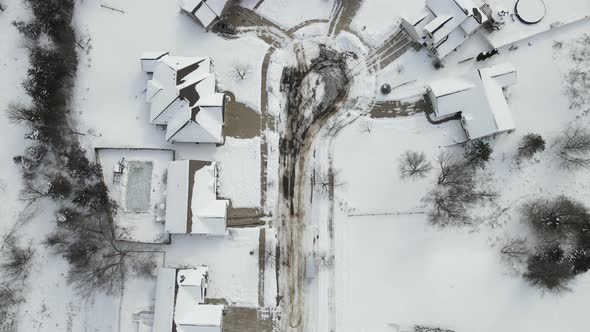 Aerial view of rural residential neighborhood covered with snow in the winter.