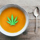 Top view of carrot soup with marijuana oil inside - Focus on oil leaf - PhotoDune Item for Sale