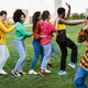 Group of multiracial people dancing together outdoor - Focus on girl wearing pink shirt - PhotoDune Item for Sale