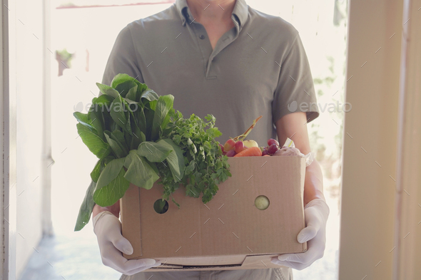 man holding grocery food box for donation,home delivering, supporting local business concept