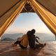 Young couple traveler looking beautiful landscape at sunset and camping on mountain - PhotoDune Item for Sale