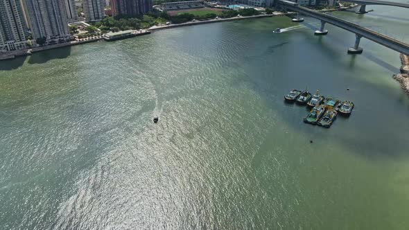 Boat cruising in middle of Rambler Channel in Tsuen Wan, Hong Kong; aerial alt