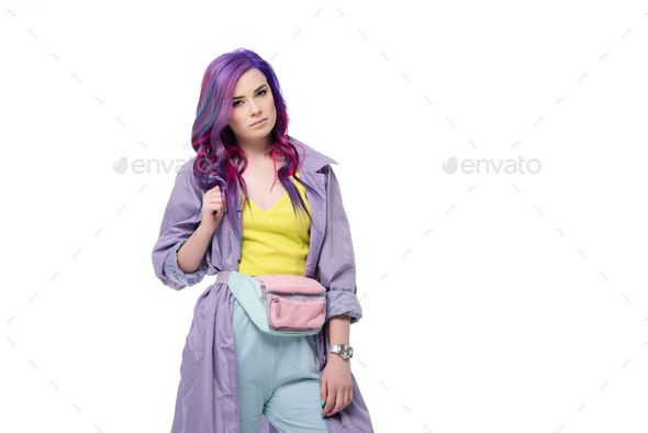 Attractive young woman with purple hair in trench coat with waist pack isolated on white