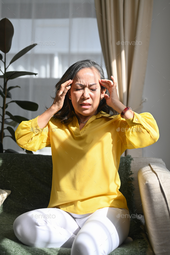 Upset stressed middle aged woman suffering from headache, migraine or dizziness. - Stock Photo - Images
