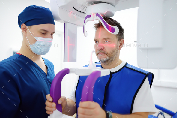 Doctor dentist are going to do a digital x-ray with man patient in dentistry clinic