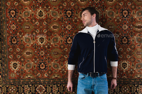 handsome young man in vintage clothes lying rug