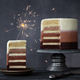 Slice of chocolate ombre birthday cake with celebration sparkler - PhotoDune Item for Sale