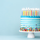 Striped buttercream birthday cake with colorful birthday candles and sprinkles - PhotoDune Item for Sale