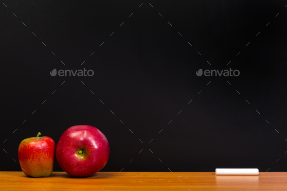 Back to school concept. Blackboard with apple on wooden desk. - Stock Photo - Images