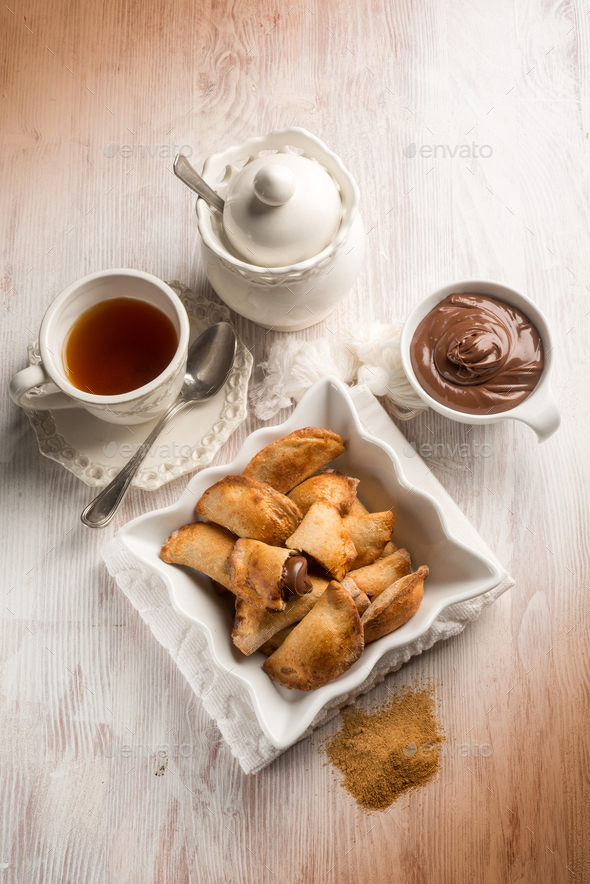 tea cup and cookie stuffed with chocolate cream - Stock Photo - Images