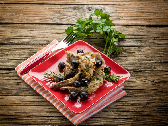 roasted rabbit with herbs and black olives - Stock Photo - Images