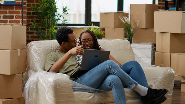 Man and woman buying furniture online on website to decorate new household