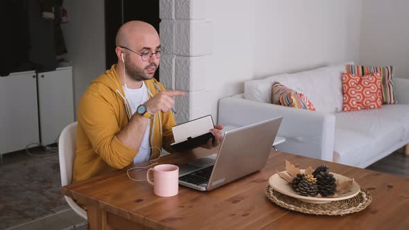 The man who has a videoconference from his home is a hardworking businessman