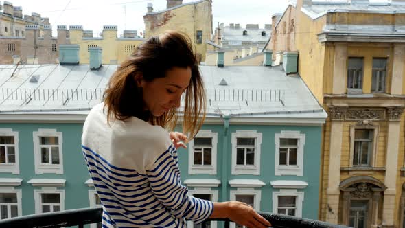 Young Woman Opening Curtains On Window At Morning And Go Out To Balcony. 