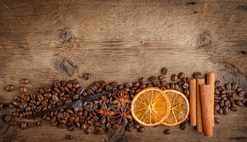 Coffee beans with ingredients on wooden background. Flat lay, copy space