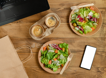 Online food delivery in disposable tableware with white blank smartphone screen.