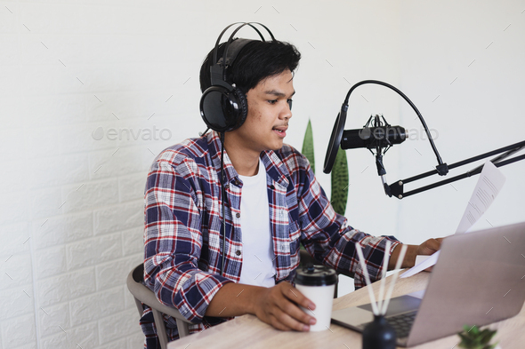 Side view of young Asian man on podcast