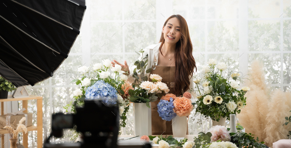 Young Asian woman in home make an online presenting and live broadcast for sale her flowers