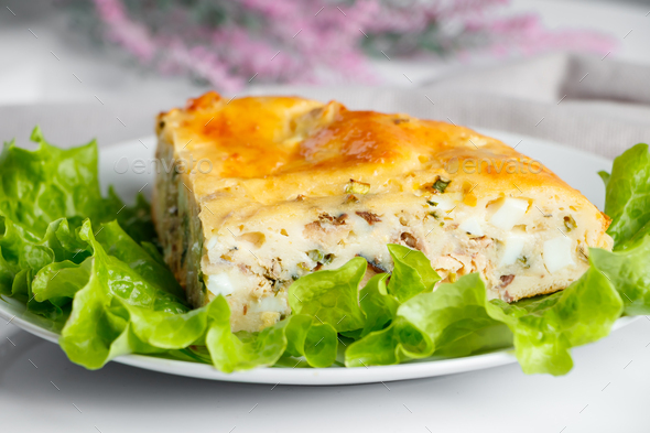 Homemade fish pie with greens on a plate. Mediterranean dish on a white background. - Stock Photo - Images