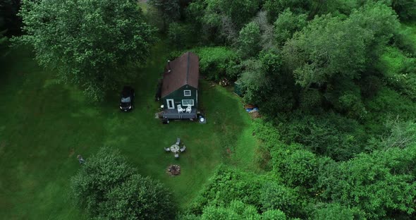 A high zoom reveal of a small secluded cabin off the grid in the Catskill Mountains New York. alt