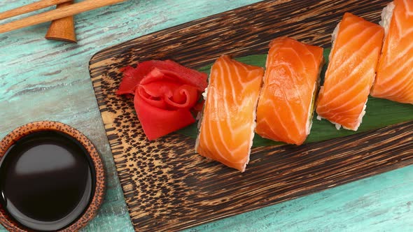 Set of salmon sushi rolls on table alt