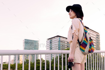 beautiful woman with backpack and a vintage camera