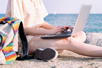 hands of young traveler woman working with laptop