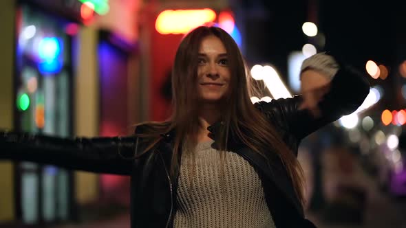 Smiling and Laughing Young Woman at The Evening Street