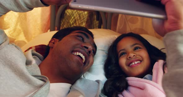 Father and daughter using digital tablet alt