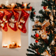 Branches of a decorated Christmas tree and a fireplace in the background - PhotoDune Item for Sale