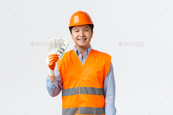 Building sector and industrial workers concept. Happy smiling asian engineer, architect in