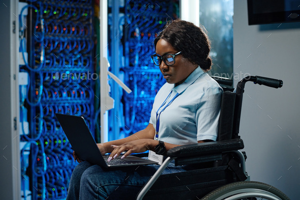 Female engineer with disability working in data center