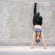 Young Asian woman make handstand upside down in the exercise - PhotoDune Item for Sale
